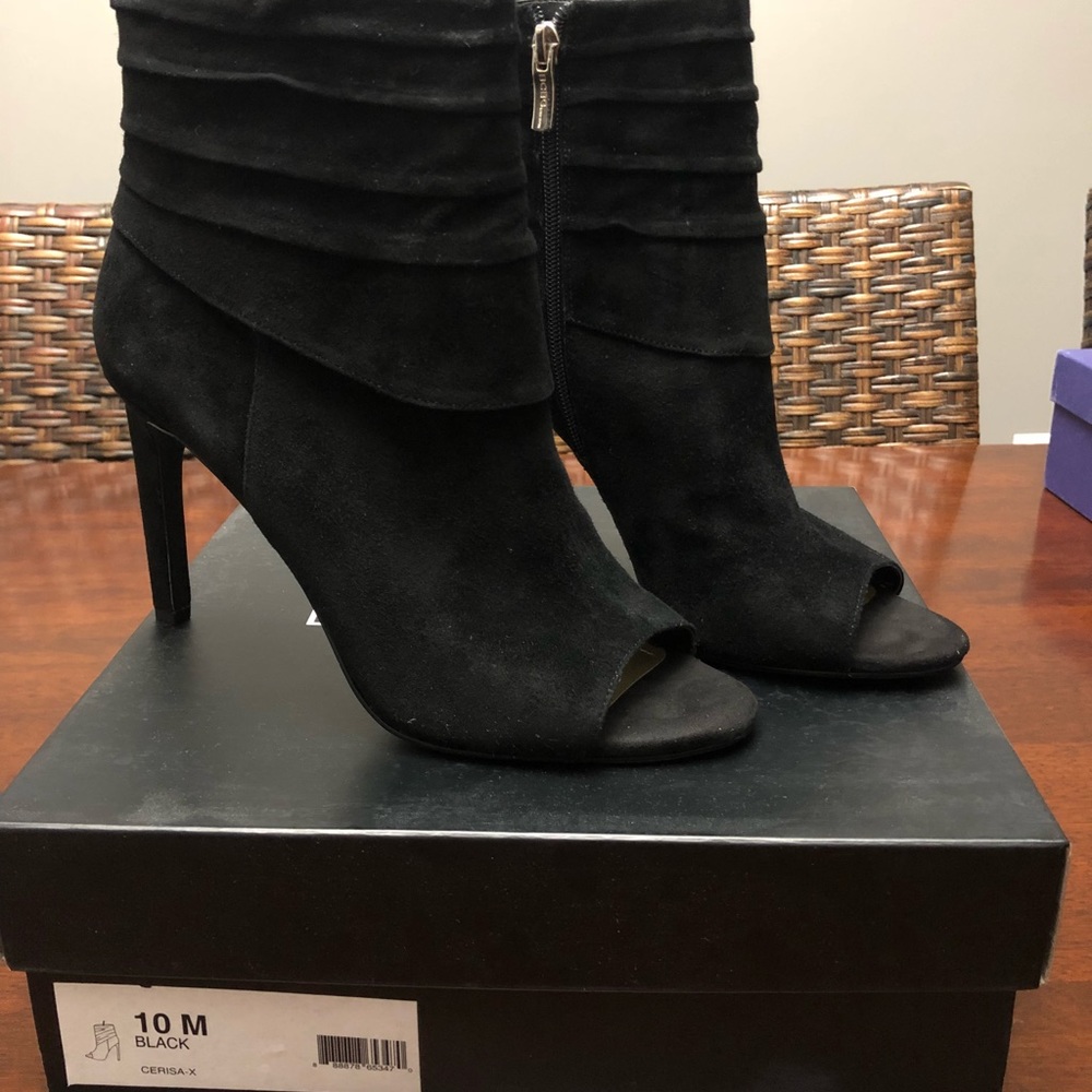 Women’s black suede BCBG heel ankle boots.